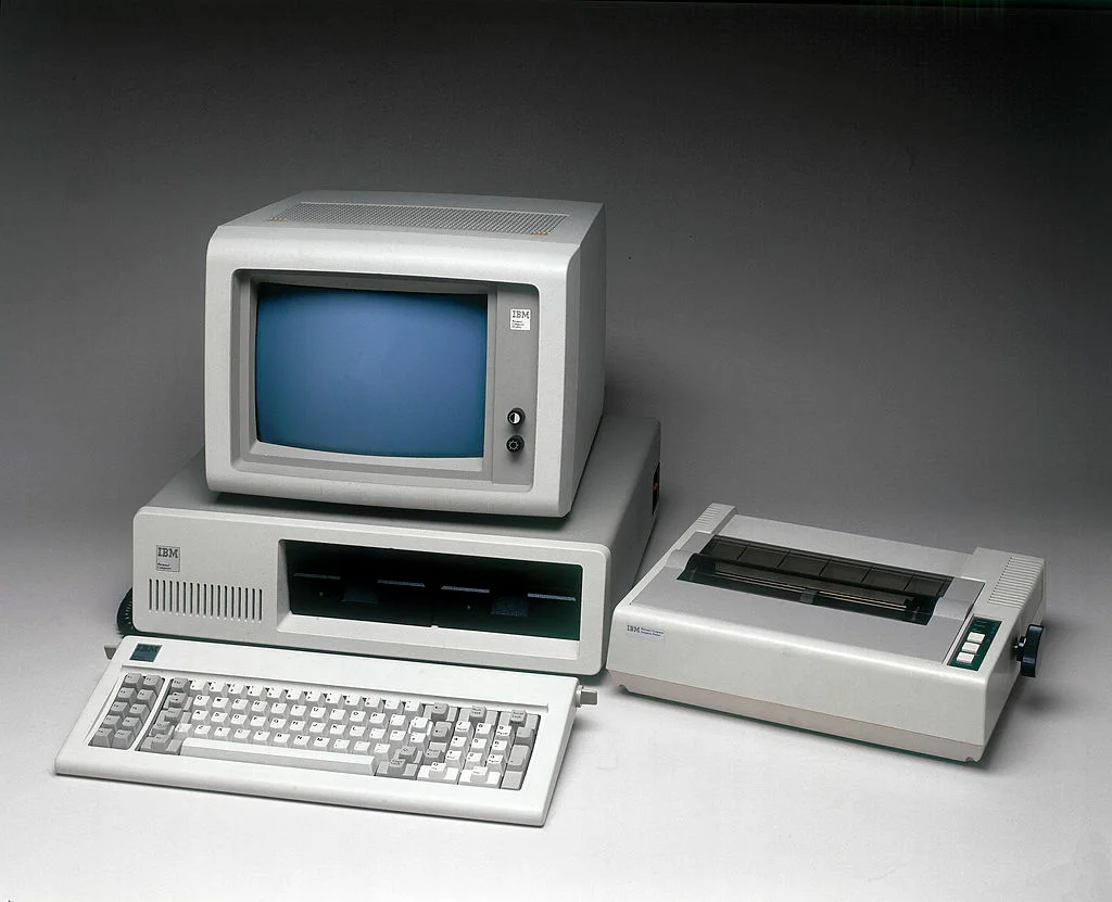 A worker using an Acorn computer by IBM, 1981